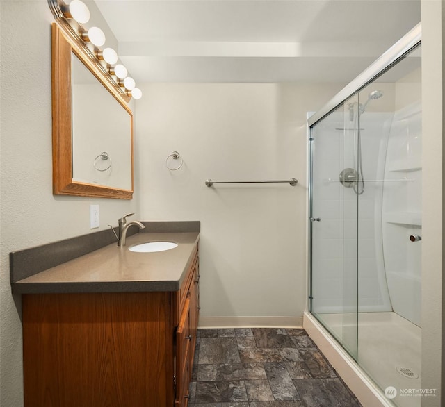 bathroom with a shower with door and vanity