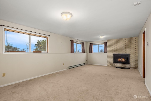 unfurnished living room with a brick fireplace, a baseboard heating unit, and light carpet