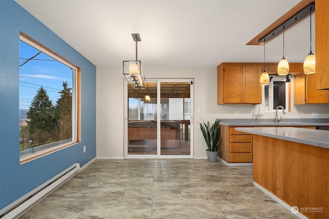 kitchen featuring sink, a baseboard radiator, and hanging light fixtures