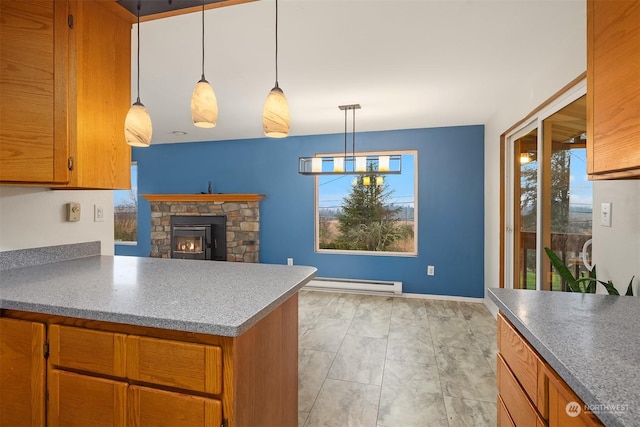 kitchen with a stone fireplace, decorative light fixtures, and baseboard heating