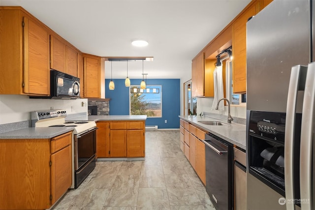 kitchen featuring sink, kitchen peninsula, hanging light fixtures, rail lighting, and appliances with stainless steel finishes