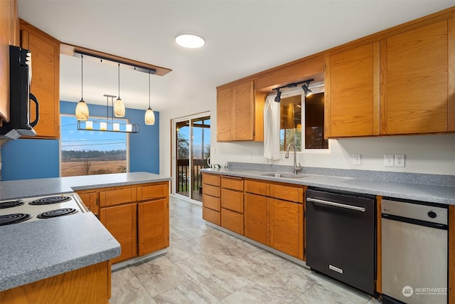 kitchen with sink, pendant lighting, black dishwasher, and rail lighting