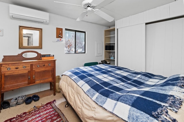 carpeted bedroom with ceiling fan, a closet, and an AC wall unit