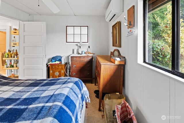 carpeted bedroom with ceiling fan and a wall mounted air conditioner