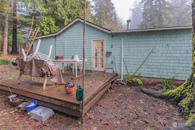 rear view of property featuring a deck