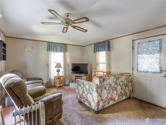 living room featuring lofted ceiling, carpet floors, and ceiling fan