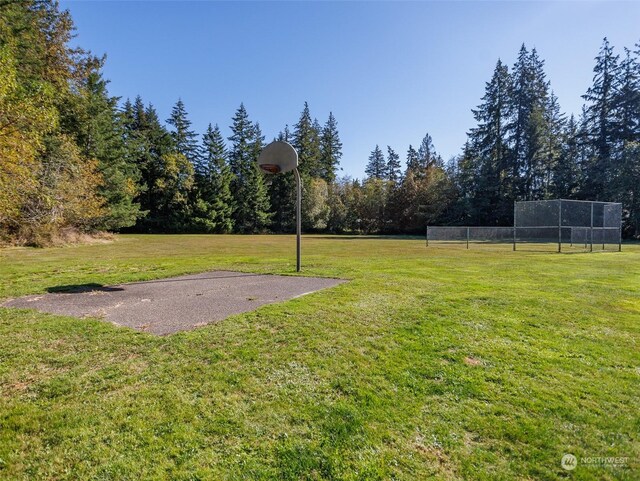 view of yard with basketball hoop