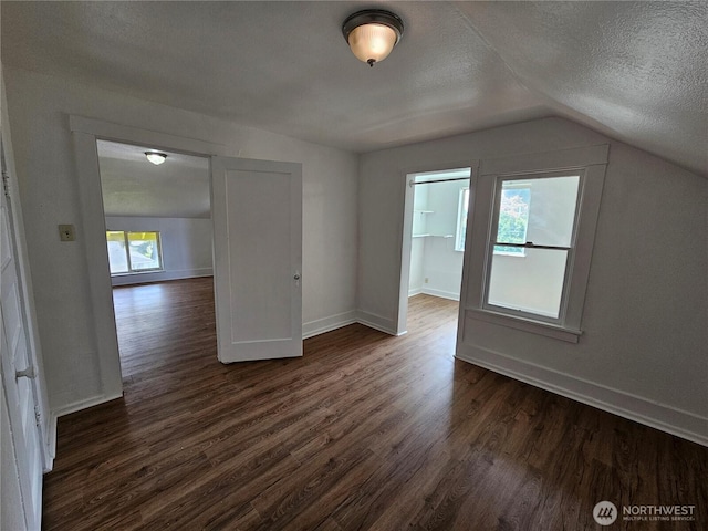 1651 S 35th St, Tacoma, WA 98418 - bonus room with dark wood finished floors, lofted ceiling, baseboards, and a textured ceiling