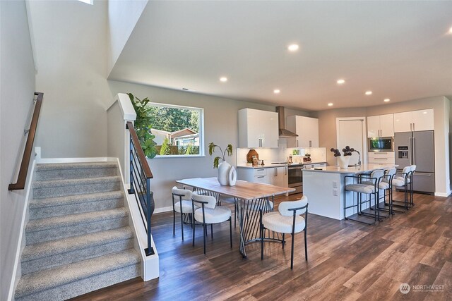 dining space featuring baseboards, stairway, dark wood finished floors, and recessed lighting