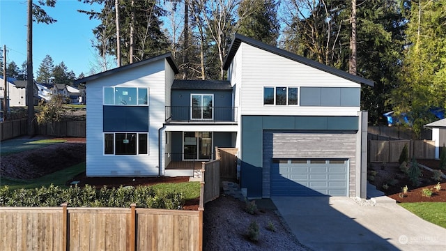 contemporary house with a balcony, a garage, fence, driveway, and crawl space