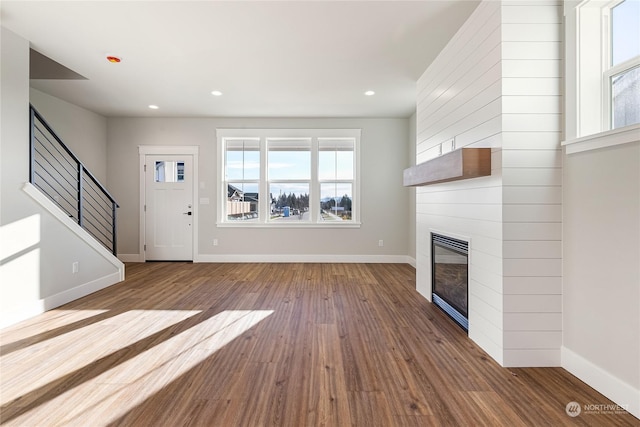 unfurnished living room featuring a fireplace and hardwood / wood-style floors