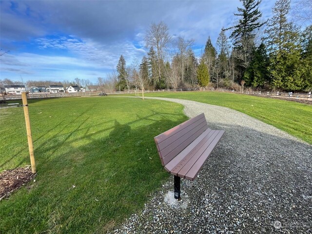 view of property's community featuring a yard