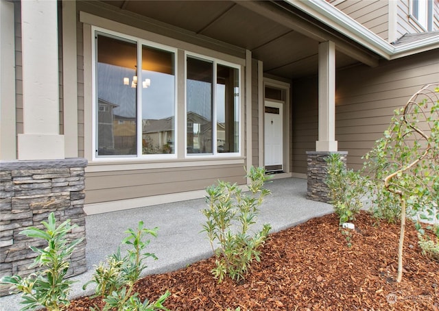 view of exterior entry with covered porch