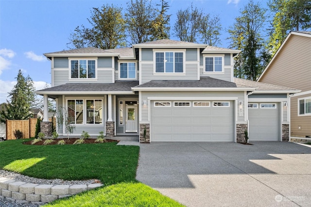 view of front of home featuring a front yard, a garage, and a porch