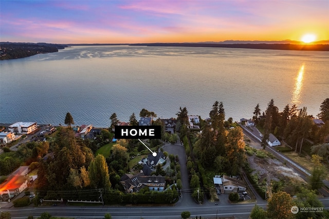 aerial view at dusk with a water view