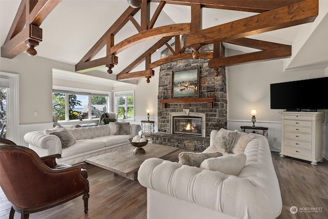 living room with dark hardwood / wood-style flooring, a fireplace, high vaulted ceiling, and beamed ceiling