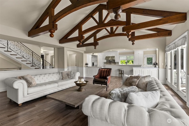 living room with high vaulted ceiling, dark hardwood / wood-style flooring, and beam ceiling