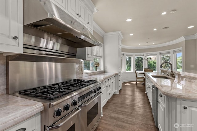 kitchen featuring light stone countertops, appliances with stainless steel finishes, white cabinets, and sink