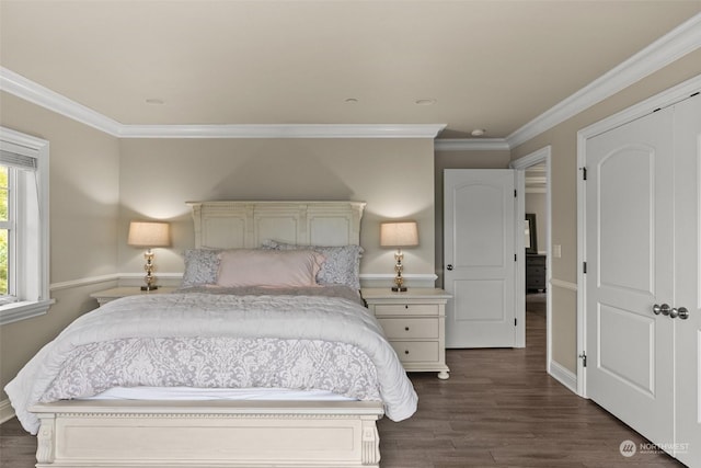 bedroom featuring a closet, dark hardwood / wood-style flooring, and crown molding