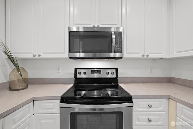 kitchen with white cabinets and appliances with stainless steel finishes