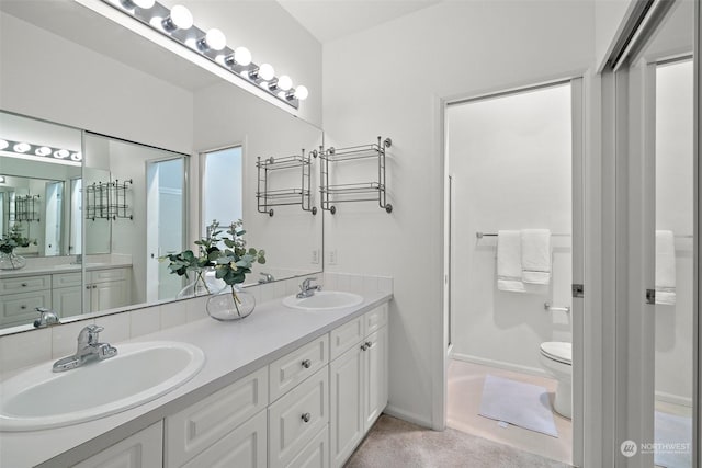 bathroom featuring toilet and vanity