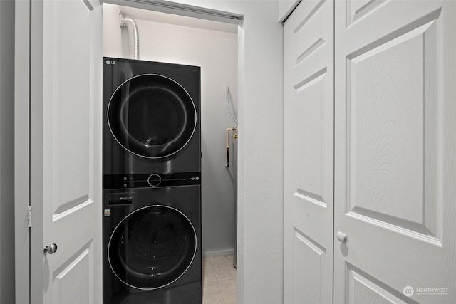 laundry area featuring stacked washer / drying machine