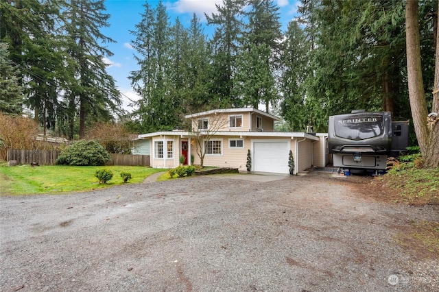 view of front property featuring a garage and a front yard