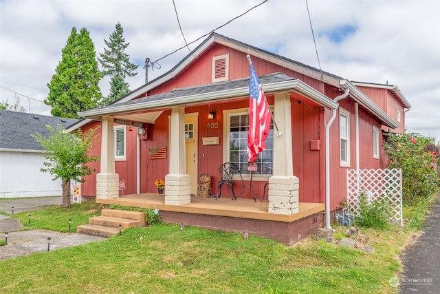 bungalow-style house featuring a porch and a front yard