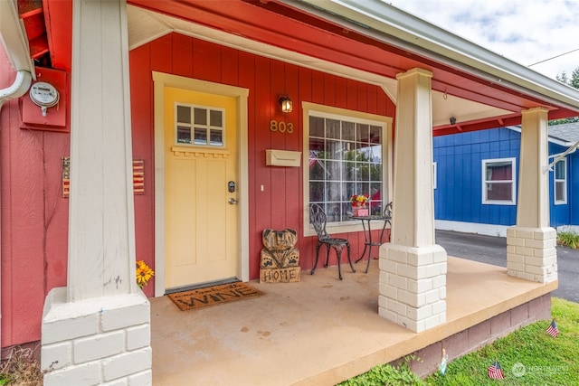 view of exterior entry with covered porch