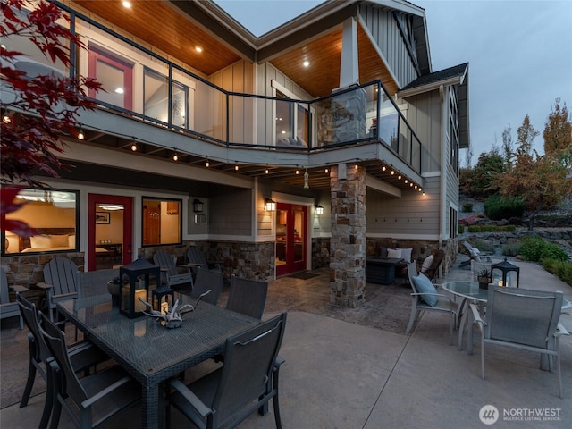 view of patio / terrace with outdoor dining space, a balcony, and french doors