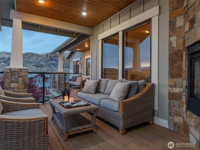 exterior space with an outdoor living space, a balcony, and a mountain view