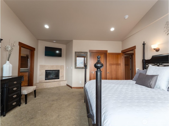 bedroom with baseboards, recessed lighting, a tile fireplace, vaulted ceiling, and light colored carpet