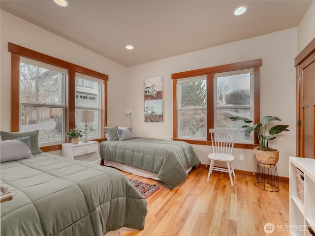 bedroom featuring light wood-style flooring, multiple windows, recessed lighting, and baseboards