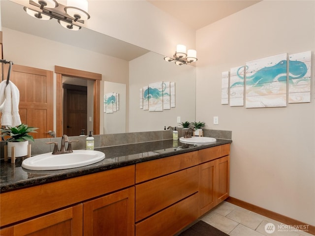 full bathroom with tile patterned flooring, double vanity, baseboards, and a sink