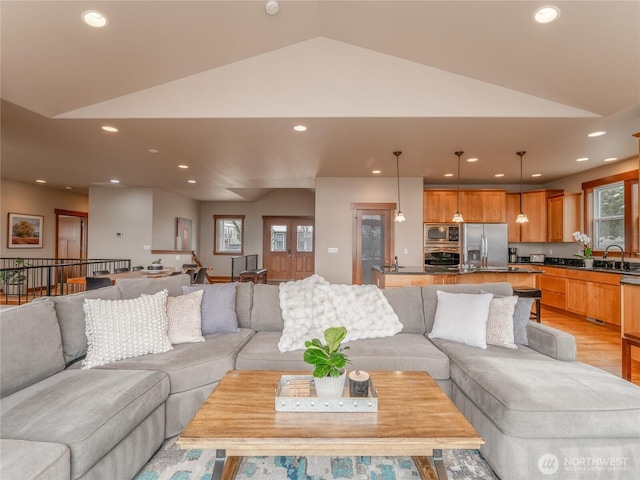 living area featuring recessed lighting, light wood-style floors, and lofted ceiling