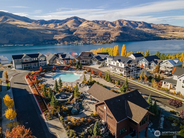 bird's eye view featuring a residential view and a water and mountain view