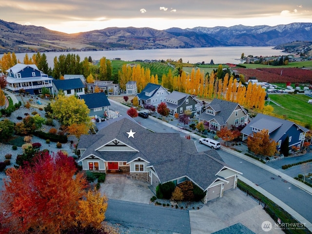 birds eye view of property featuring a residential view and a water and mountain view