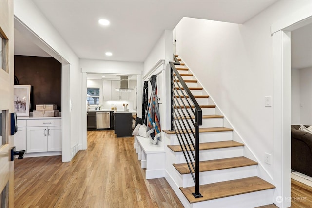 stairway featuring wood-type flooring