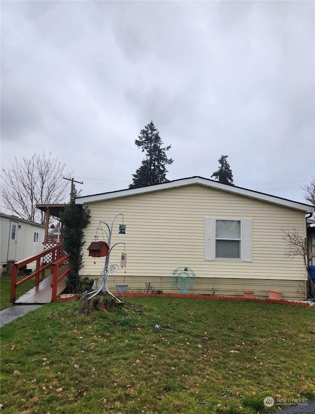 view of side of property with a lawn