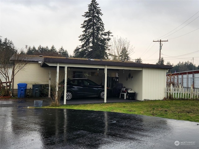 garage featuring a yard and a carport