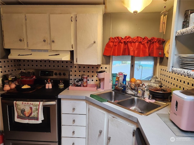 kitchen featuring white cabinets, stainless steel electric range, tasteful backsplash, and sink