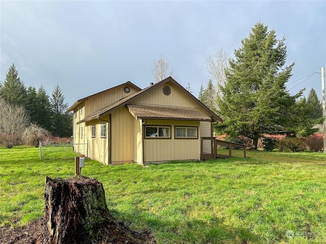 view of side of property with a lawn