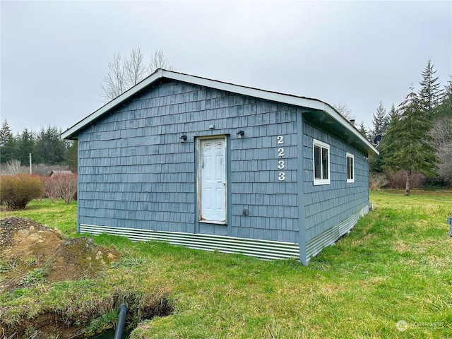 view of side of home with a lawn