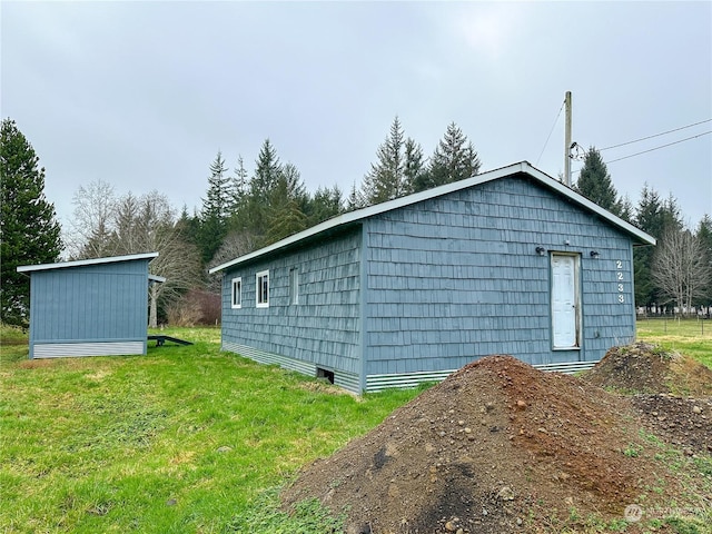 view of outdoor structure featuring a lawn