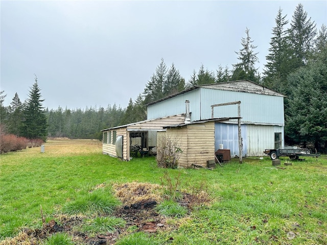 view of outbuilding featuring a lawn