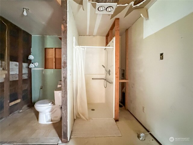 bathroom with toilet and walk in shower