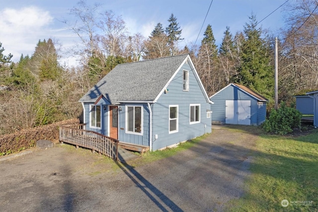 view of front of property featuring a storage shed and a wooden deck