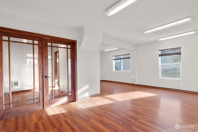 spare room with light hardwood / wood-style flooring