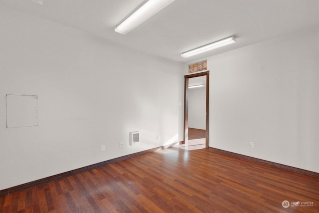 empty room with dark wood-type flooring