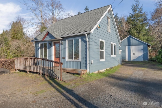 exterior space featuring a wooden deck and a storage shed